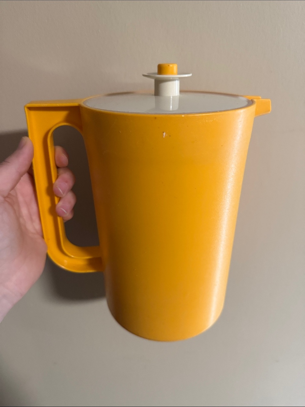 vintage yellow Tupperware pitcher with a white push-button lid